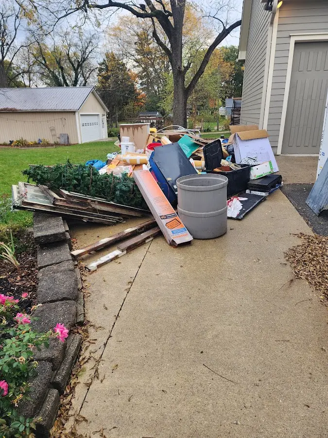 Dumpster being loaded with debris for 10 Yard Dumpster Rental in Edina